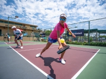 Pickleball player giving a lesson on technique in instructional video.