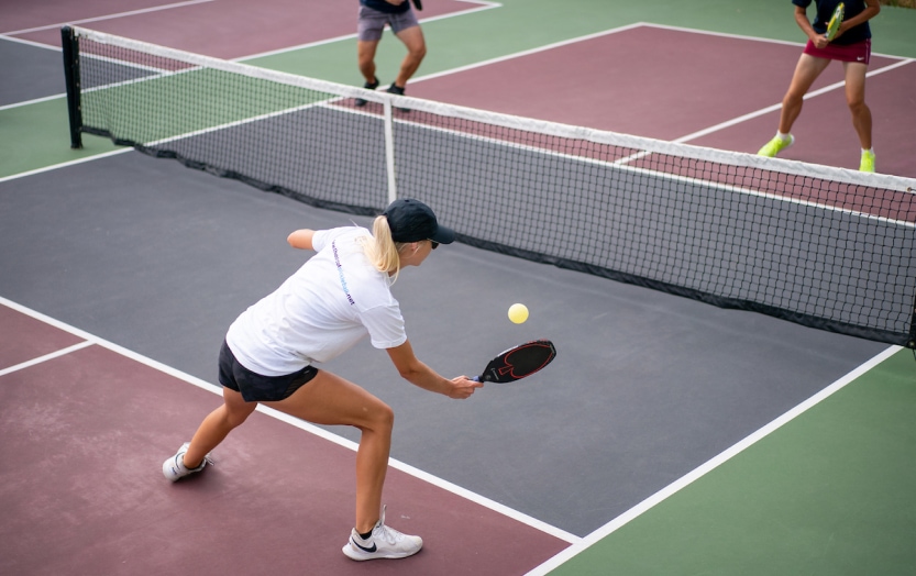 The Art of Pickleball pros demonstrating the correct pickleball form in instructional video.